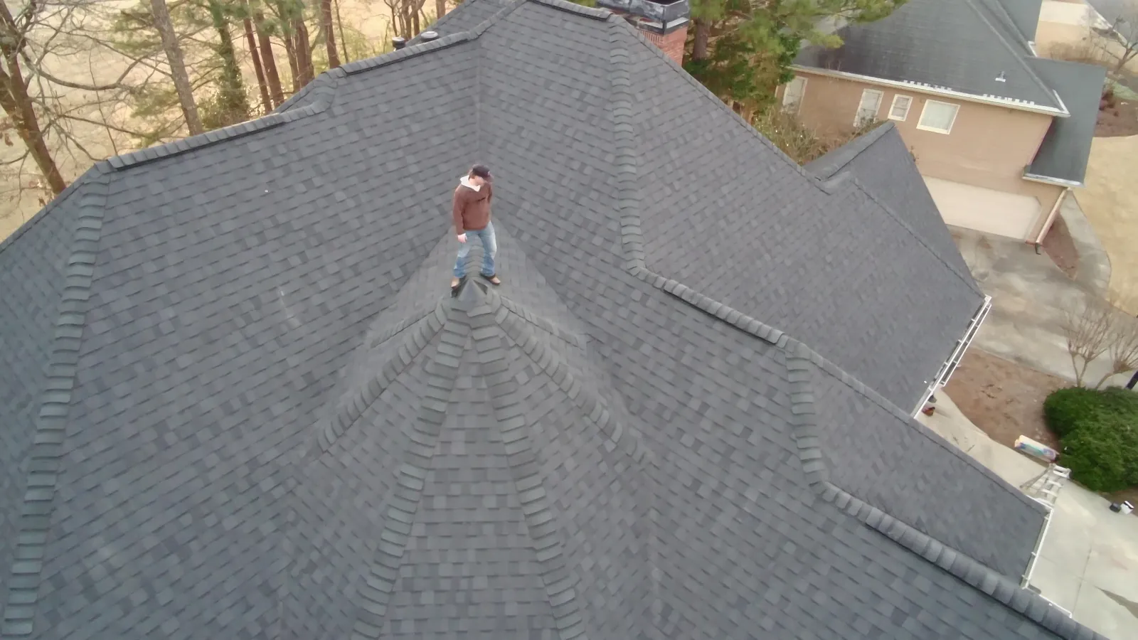 Snapper Roofing project manager standing on a new architectural shingle roof in Atlanta